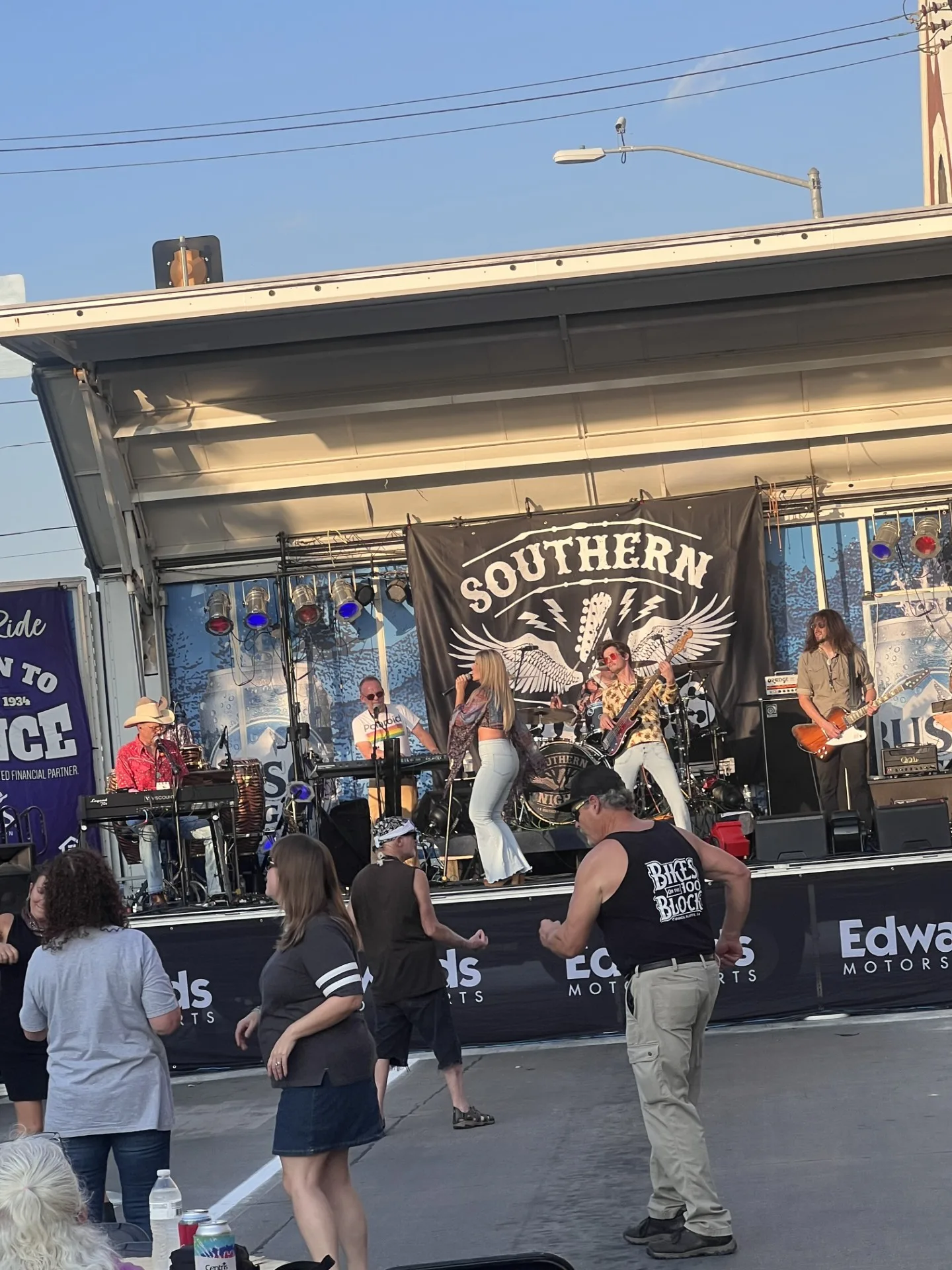 Crowd enjoying live music by the Southern Nights band at Bike Night, with people dancing in front of the stage.