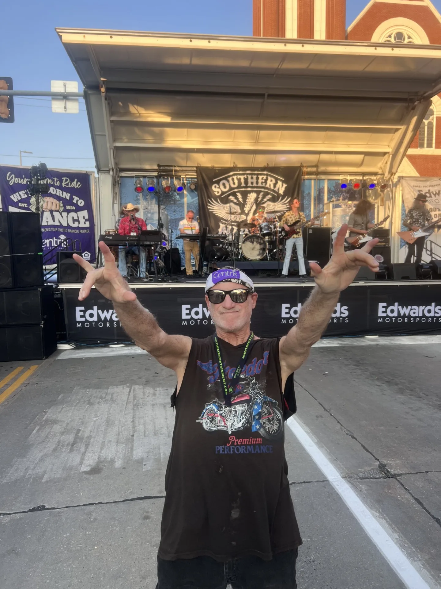 Roger posing in front of a live band at Bike Night, showing his excitement and love for the event.